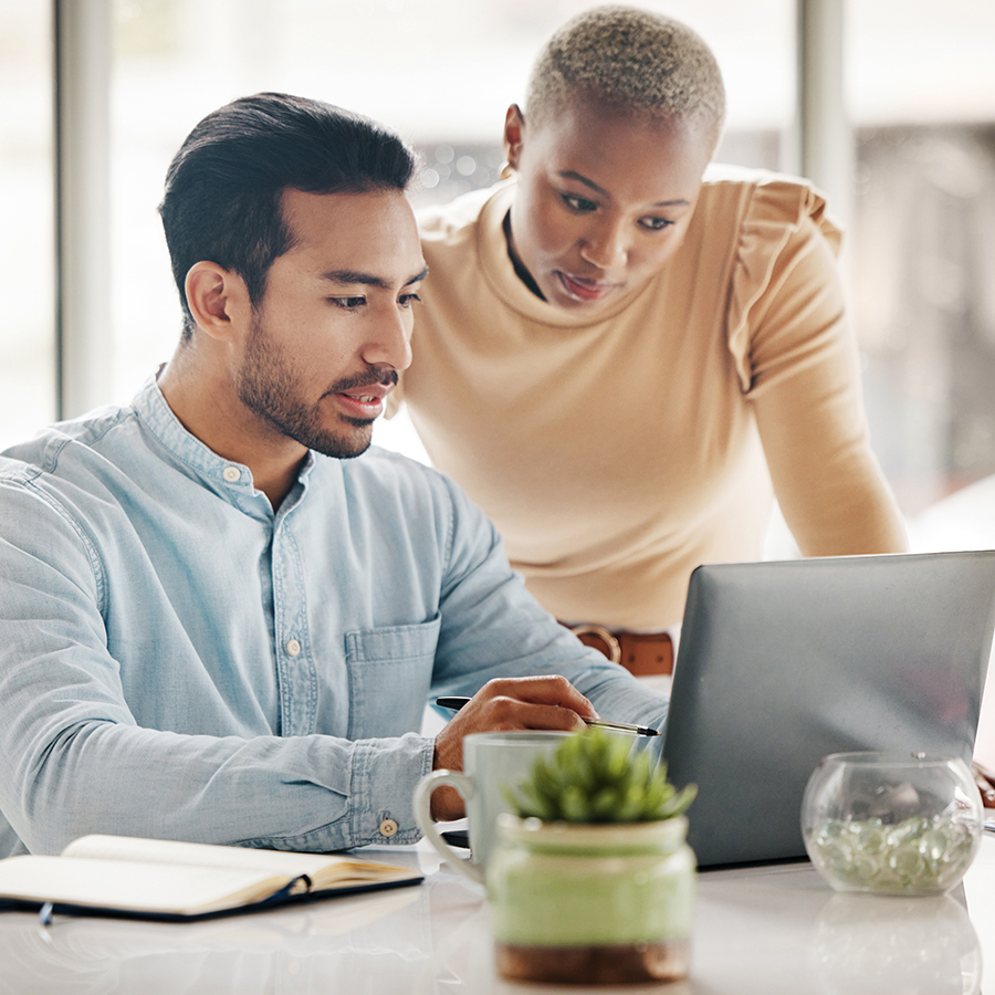 Marketing team members discussing metrics over computer