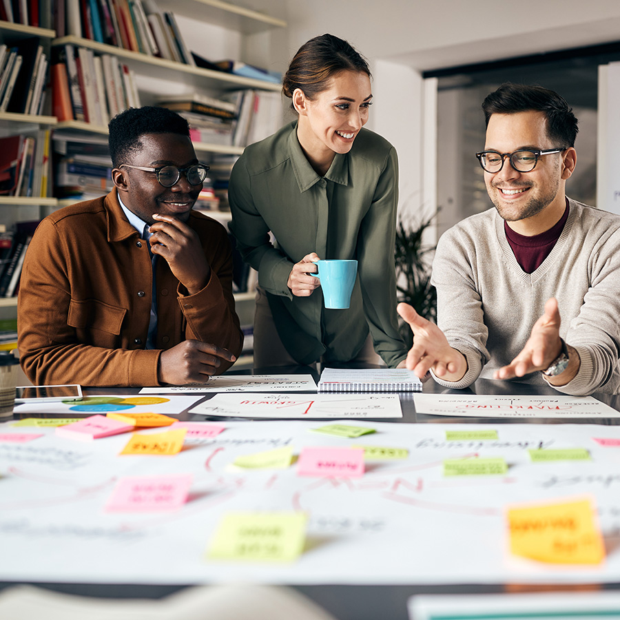 Marketing team members discussing metrics over computer