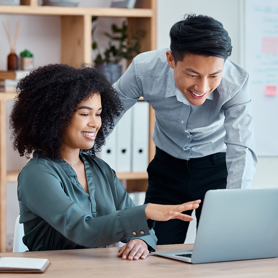 Marketing team members discussing metrics over computer